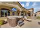 A covered back patio featuring a hot tub and a television at 8325 W Cantera Ave, Peoria, AZ 85383