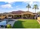 Lush backyard featuring a pool and outdoor living space at 8325 W Cantera Ave, Peoria, AZ 85383