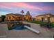Well-manicured backyard with a sparkling pool, patio, and palm trees at 8325 W Cantera Ave, Peoria, AZ 85383