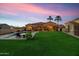 Inviting backyard with a pool, patio, and serene twilight at 8325 W Cantera Ave, Peoria, AZ 85383