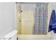 Bathroom features a shower with patterned curtains and a toilet at 8325 W Cantera Ave, Peoria, AZ 85383