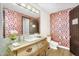 Bathroom features a ornate golden vanity, unique floral wall paper, and a large mirror at 8325 W Cantera Ave, Peoria, AZ 85383
