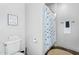 Bathroom featuring a toilet, patterned shower curtain, and a cozy rug at 8325 W Cantera Ave, Peoria, AZ 85383