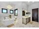 Luxury bathroom features a soaking tub, chandelier, and marble flooring at 8325 W Cantera Ave, Peoria, AZ 85383