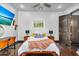 Bedroom with dark wood floors, wooden bed frame, modern decor and a flatscreen TV at 8325 W Cantera Ave, Peoria, AZ 85383