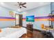 Sporty bedroom with hardwood floors, basketball hoop, ceiling fan, and a flat-screen TV at 8325 W Cantera Ave, Peoria, AZ 85383