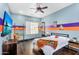 Eclectic bedroom with desk, TV, and colorful Phoenix Suns decor at 8325 W Cantera Ave, Peoria, AZ 85383
