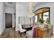 Elegant dining area featuring a custom chandelier, designer seating, and natural light from a large window at 8325 W Cantera Ave, Peoria, AZ 85383