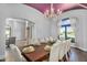 Elegant dining room with chandelier and large table with seating for ten at 8325 W Cantera Ave, Peoria, AZ 85383