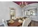 Dining room features a statement mirror, arched entry and seating for ten at 8325 W Cantera Ave, Peoria, AZ 85383