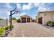 Spacious driveway and garages featuring brick pavers and mature landscaping, basketball hoop included at 8325 W Cantera Ave, Peoria, AZ 85383