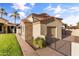 Charming home exterior with a tile roof, stone accents, a small garage, and desert landscaping at 8325 W Cantera Ave, Peoria, AZ 85383