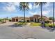 Beautiful home exterior with lush landscaping, palm trees, and brick driveway on a sunny day at 8325 W Cantera Ave, Peoria, AZ 85383