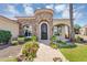 Elegant front entry with stone accents, lush flowers, and a well-manicured lawn at 8325 W Cantera Ave, Peoria, AZ 85383