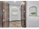 Hallway featuring custom wood doors and arch niche at 8325 W Cantera Ave, Peoria, AZ 85383