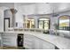 Kitchen showcases a beverage fridge and large island with granite countertops at 8325 W Cantera Ave, Peoria, AZ 85383