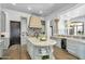 Elegant kitchen featuring custom cabinets, granite countertops, a center island, and state-of-the-art appliances at 8325 W Cantera Ave, Peoria, AZ 85383