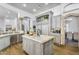 Modern kitchen with an island, granite countertops, stainless steel appliances, and custom cabinetry at 8325 W Cantera Ave, Peoria, AZ 85383