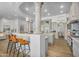 Stunning kitchen boasts custom cabinets, granite countertops, stainless appliances, and a breakfast bar with seating at 8325 W Cantera Ave, Peoria, AZ 85383