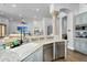 Open-concept kitchen with stainless appliances, granite counters, and breakfast bar at 8325 W Cantera Ave, Peoria, AZ 85383