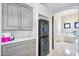 Adjacent to bathroom: Stacked washer/dryer and built-in storage cabinets at 8325 W Cantera Ave, Peoria, AZ 85383