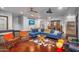Open living room featuring a blue sofa, glass coffee table, and a patterned hide rug at 8325 W Cantera Ave, Peoria, AZ 85383