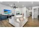 Spacious living room with comfortable seating, stylish decor, an entertainment center, and hardwood floors at 8325 W Cantera Ave, Peoria, AZ 85383