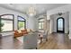 Elegant living room with hardwood floors, a chandelier, and large windows for natural light at 8325 W Cantera Ave, Peoria, AZ 85383