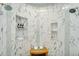 Modern shower with dual shower heads, bench seat, and niche storage at 8325 W Cantera Ave, Peoria, AZ 85383