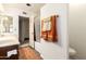 Bathroom features a single vanity, tub with glass doors, and wood-look flooring at 8540 N 43Rd Dr, Glendale, AZ 85302