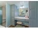 Bright bathroom vanity with seating, storage cabinets, and a glass door shower at 8540 N 43Rd Dr, Glendale, AZ 85302