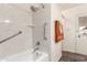 Clean bathroom featuring a shower-tub combo, marble-style walls, and safety grab bars at 8540 N 43Rd Dr, Glendale, AZ 85302