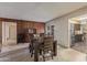 Classic dining room with wood paneling, modern dining table, and easy access to kitchen at 8540 N 43Rd Dr, Glendale, AZ 85302