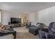 Comfortable living room featuring sofas, an entertainment center, and neutral decor at 8540 N 43Rd Dr, Glendale, AZ 85302