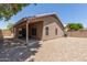 Private backyard with low-maintenance gravel, covered patio, and block fence, perfect for outdoor enjoyment at 8569 W Voltaire Ave, Peoria, AZ 85381