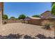 Expansive gravel backyard surrounded by a brick wall, offering privacy and low maintenance at 8569 W Voltaire Ave, Peoria, AZ 85381