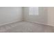 Neutral bedroom with soft carpet, light walls, window, and ample space for personalization and comfort at 8569 W Voltaire Ave, Peoria, AZ 85381