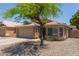 Street view of a single-story home with desert landscaping and a mature shade tree at 8569 W Voltaire Ave, Peoria, AZ 85381