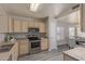Kitchen featuring stainless steel appliances and light-colored cabinetry with a view into the dining area at 8569 W Voltaire Ave, Peoria, AZ 85381