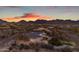 Picturesque aerial view of the home displays its desert setting, with mountain views and landscaping at 9301 E Via Montoya --, Scottsdale, AZ 85255