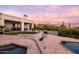 Elegant outdoor living space featuring a pool, patio, grill, fire pit, covered seating, and stunning views at 9301 E Via Montoya --, Scottsdale, AZ 85255
