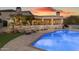 Home's backyard features a pool, desert landscaping, and outdoor seating areas, perfect for entertaining at 9301 E Via Montoya --, Scottsdale, AZ 85255
