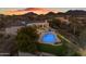 Beautiful home backyard with a sparkling pool, manicured artificial lawn, and desert views for relaxing outdoor living at 9301 E Via Montoya --, Scottsdale, AZ 85255