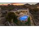 Stunning backyard features a pristine pool, spa, and outdoor entertaining area set against a desert landscape at 9301 E Via Montoya --, Scottsdale, AZ 85255