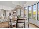 Breakfast nook with a round wood table and modern chandelier, adjacent to the kitchen at 9301 E Via Montoya --, Scottsdale, AZ 85255