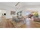 Spacious dining room featuring a rustic table, modern lighting, and a view of the piano room at 9301 E Via Montoya --, Scottsdale, AZ 85255