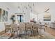 Bright dining room with wood table, seating for eight, modern lighting and light wood floors at 9301 E Via Montoya --, Scottsdale, AZ 85255