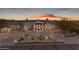 Stunning home featuring desert landscaping, a circular driveway, and a grand entrance at sunset at 9301 E Via Montoya --, Scottsdale, AZ 85255