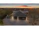 Striking three-car garage with modern glass doors and mountain views at dusk at 9301 E Via Montoya --, Scottsdale, AZ 85255