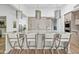Kitchen island with marble countertop, white cabinets, and seating for four at 9301 E Via Montoya --, Scottsdale, AZ 85255